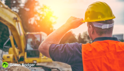Subcontractor standing by an excavator